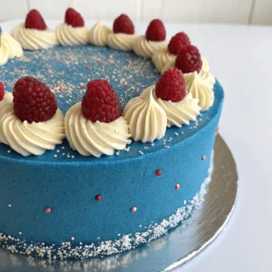 A slice of blue velvet cake on a white plate with a fork.